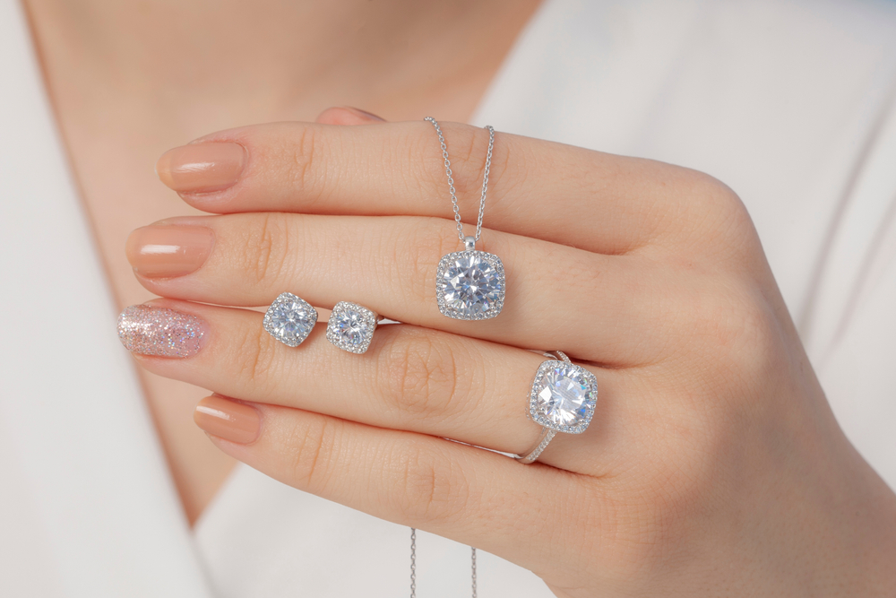 square stone diamond jewelry set in white outfit lady hands