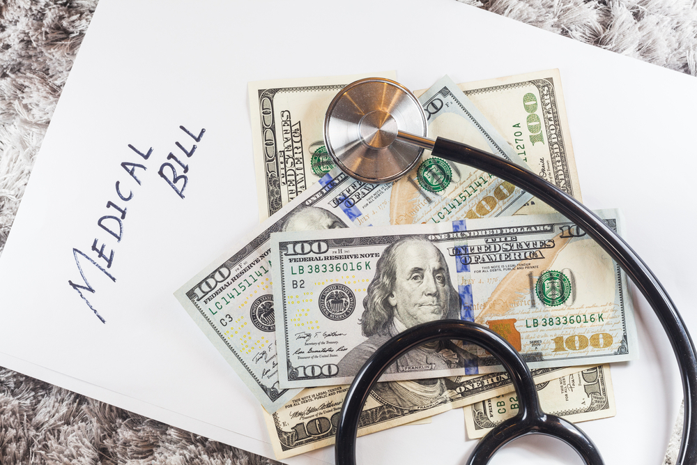 stethoscope with wording of medical bill showing expensive healthcare